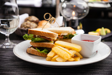 Sandwich with fried eggs, bacon and lettuce