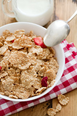 cereals with dry fruits in white bowl and milk