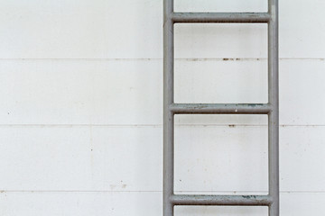 Obraz na płótnie Canvas steel ladder on the dirty wall