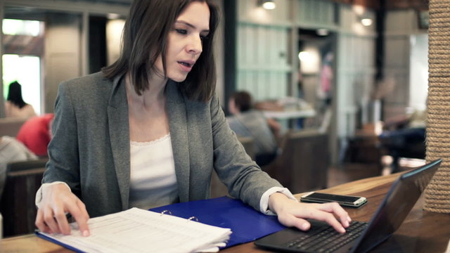 Young businesswoman working with laptop and documents