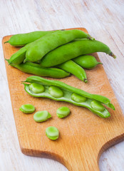 Fresh broad bean on kitchen board