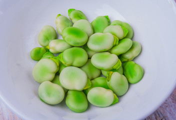 Fresh broad bean in white bowl