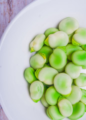 Fresh broad bean in white bowl