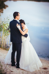 Fototapeta na wymiar wedding: bride and groom on the seashore.