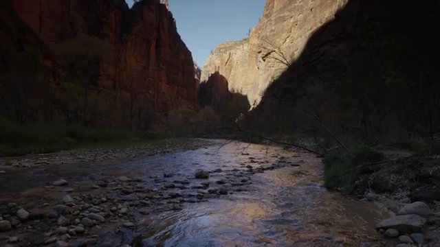 Panning shot of stream and cliff in Zion National Park / Zion National Park, Utah, United States, 