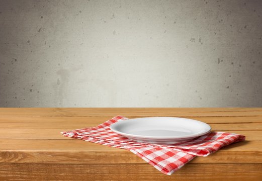 Plate. Empty white plate on wooden table over red grunge