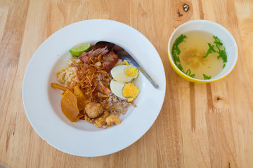 Asian dry noodle with garnish on the wooden background