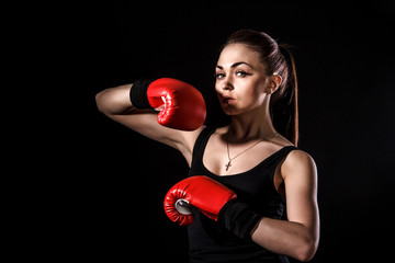 Beautiful young woman in a red boxing gloves