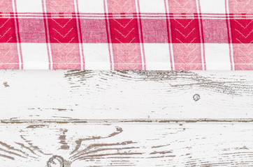 Red tablecloth over white wooden table