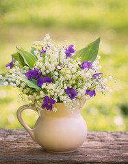 Beautiful bouquet of lilies of the valley and violets