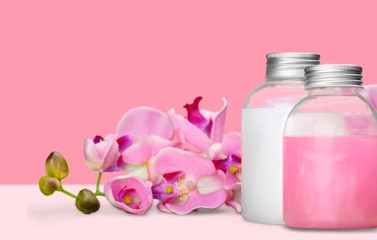 Obraz na płótnie Canvas Cosmetics. Pink soap bottles and flowers