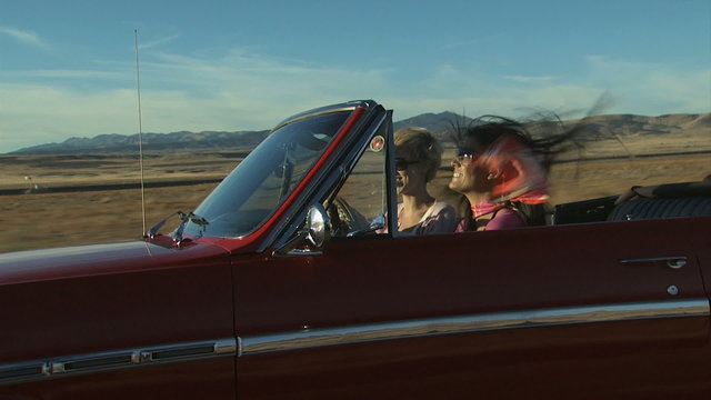 vintage red convertible driving