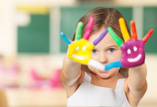 Arm. Painted children's hands in different colors with smilies