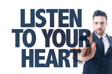 Business man pointing the text: Listen To Your Heart