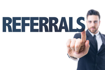 Business man pointing the text: Referrals