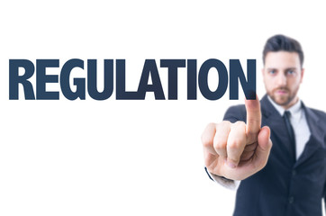 Business man pointing the text: Regulation