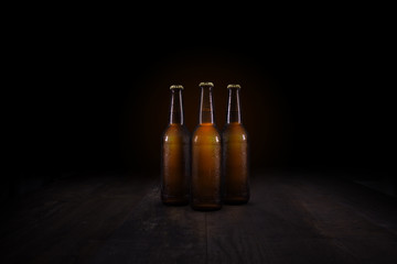 3 beer bottles on a rustic table