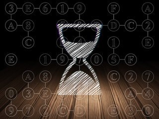 Time concept: Hourglass in grunge dark room