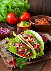 Mexican tacos with meat, vegetables and red onion