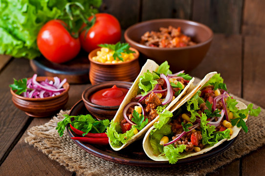 Mexican tacos with meat, vegetables and red onion