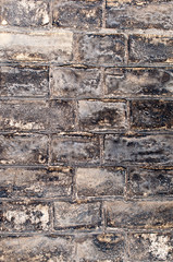 Weathered yellow brick wall