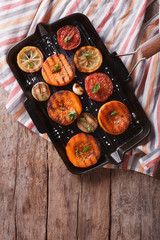Grilled pumpkin and vegetables on grill. Top view vertical 
