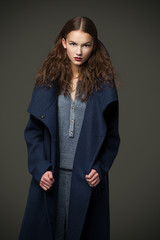 fashion model woman coat and hat urban style pose on color © Rattleray