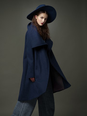fashion model woman coat and hat urban style pose on color - 82500823