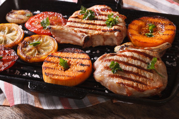 Grilled pork, pumpkin and lemon on a grill pan. Horizontal