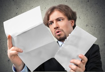 Shock. Man Opens Letter with Shocked Expression