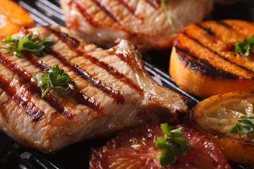Grilled pork steak and vegetables on the grill. Horizontal macro