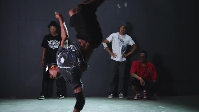 WS Studio shot of young man breakdancing