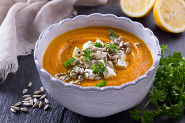 Carrot soup with feta cheese, sunflower seeds and parsley