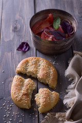 Sesame flat bread with a salad of tomatoes, red onion and basil 