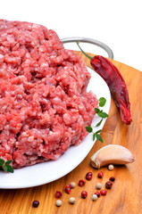 minced meat with pepper, thyme and garlic on cutting board isola