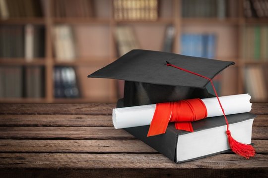 Graduation. Diploma and graduation cap