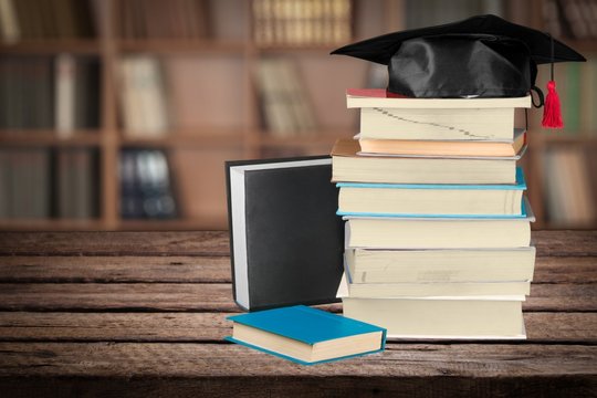 Graduation. Graduation cap on books