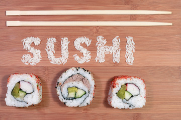 sushi pieces and sushi rice written on bamboo 
