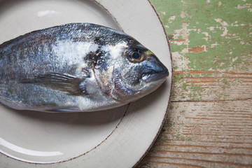 Fresh fish (Sparus aurata) with lemon and parsley
