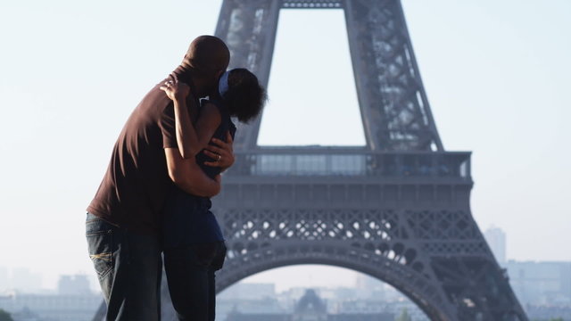 couple kissing and hugging in front of the Eiffel tower