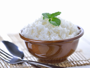 Cooked white rice garnished with mint in a ceramic bowl