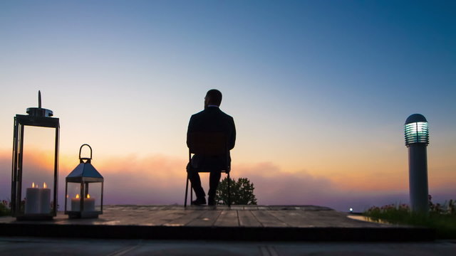 business man look sunrise on terrace