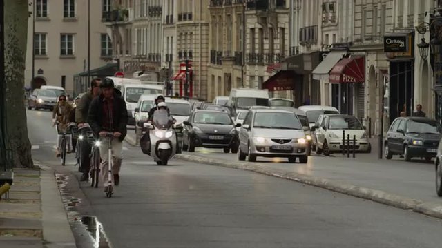 Slow motion/medium shot of traffic on city street / Paris, France