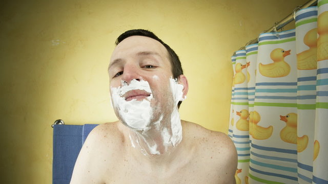 A young man shaving