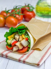 Tortilla wraps with roasted chicken, fresh vegetables and sauce