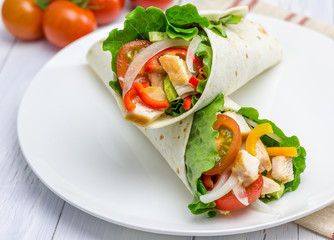 Tortilla wraps with roasted chicken, vegetables and sauce