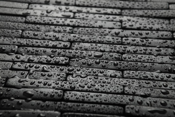 Black tile background with water