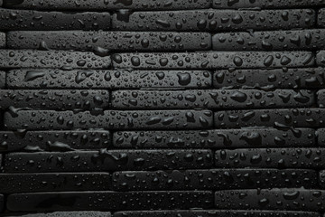 Black tile background with water