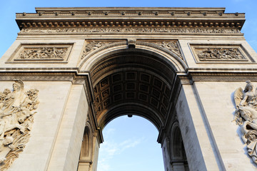Arc de Triomphe paris france famous landmark monument looking up upwards view blue sky background...