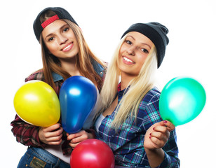 Fototapeta na wymiar hipster girls smiling and holding colored balloons